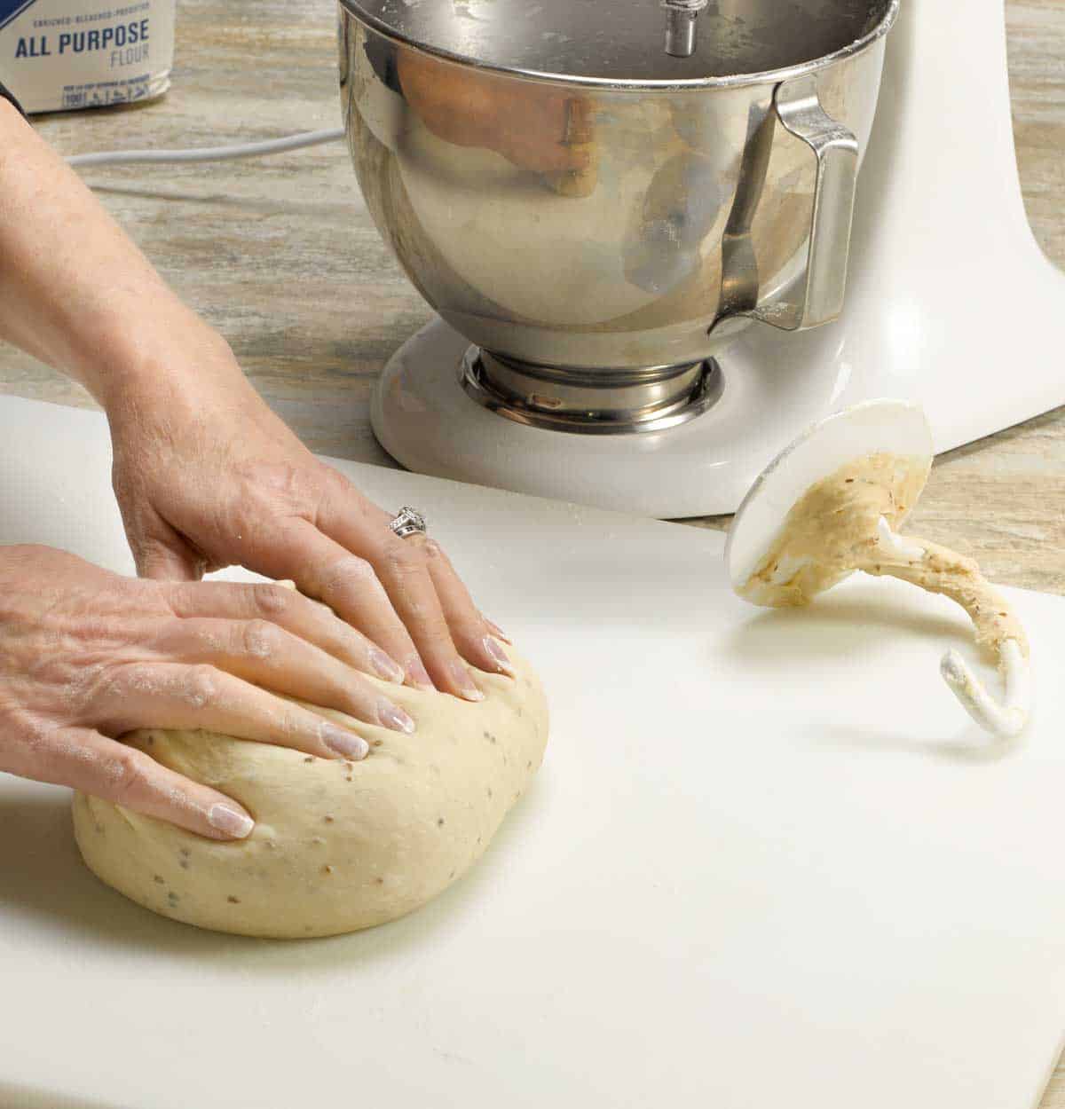 Process shot showing two hands kneading Anise Bread dough