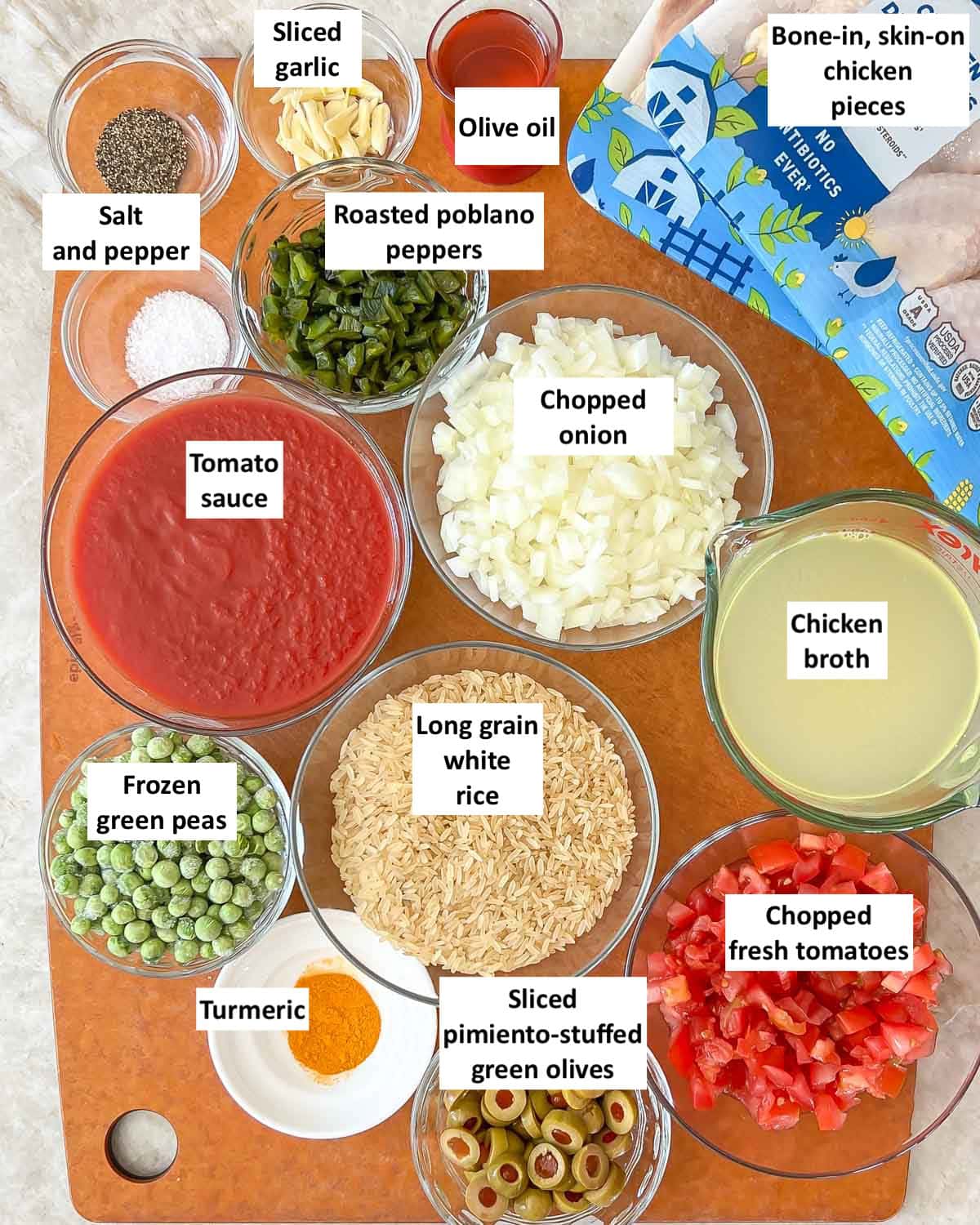 Overhead view of all ingredients in this Arroz Con Pollo recipe, with labels