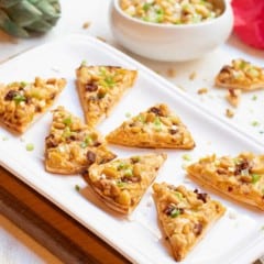 artichoke, sundried tomato and feta triangles on platter