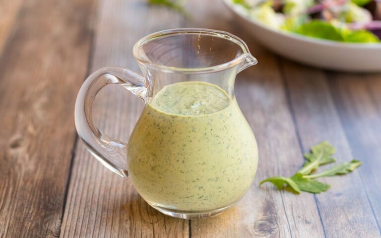 CLose up of Arugula Salad Dressing in a glass pitcher