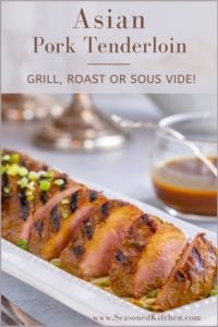 white platter filled with slices of Asian Pork Tenderloin. Bowl if rice and candles in the background