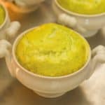 close up of white dish showing individual cooked Asparagus Soufflé