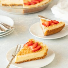 Two slices of Baked Cheesecake with the rest of the cake in the background
