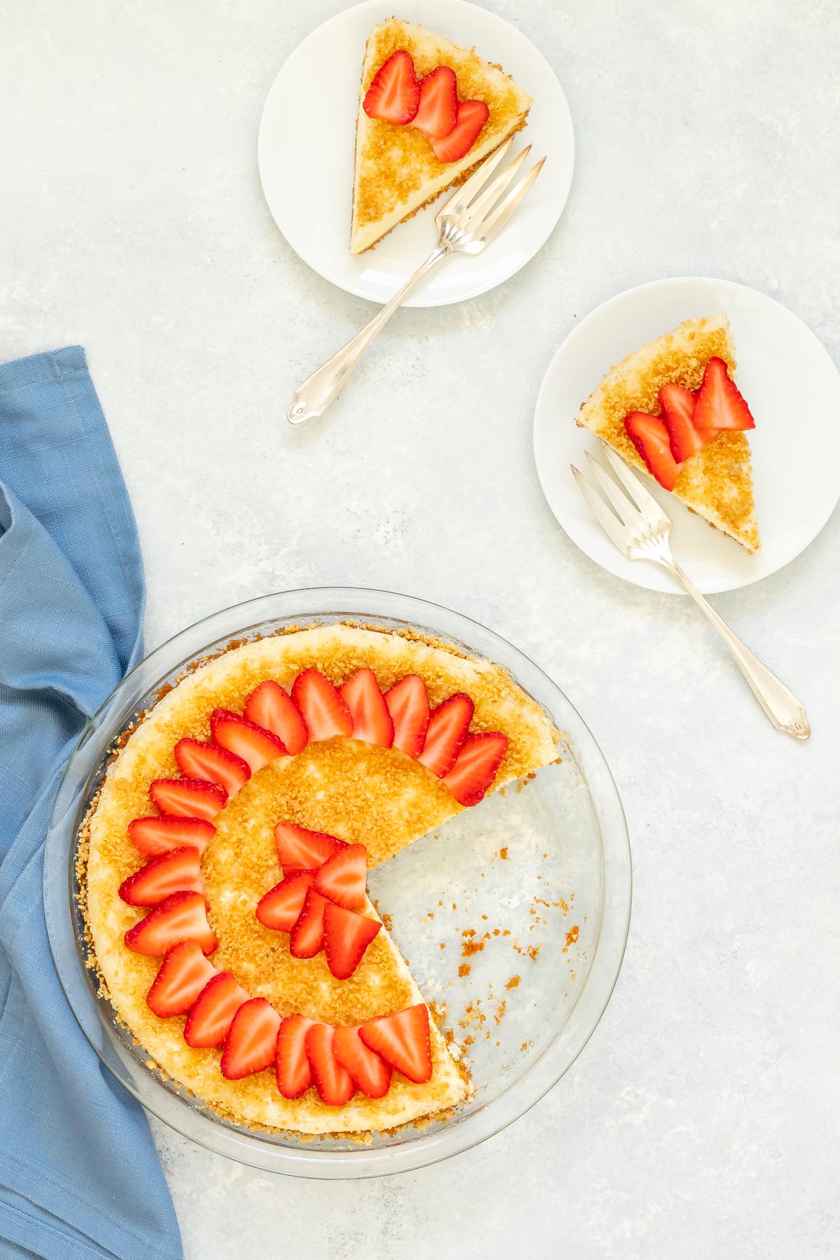 Overhead view of Baked Cheesecake with two slices cut out and sitting alongside