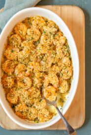 overhead shot of Baked Shrimp with a spoon holding one shrimp