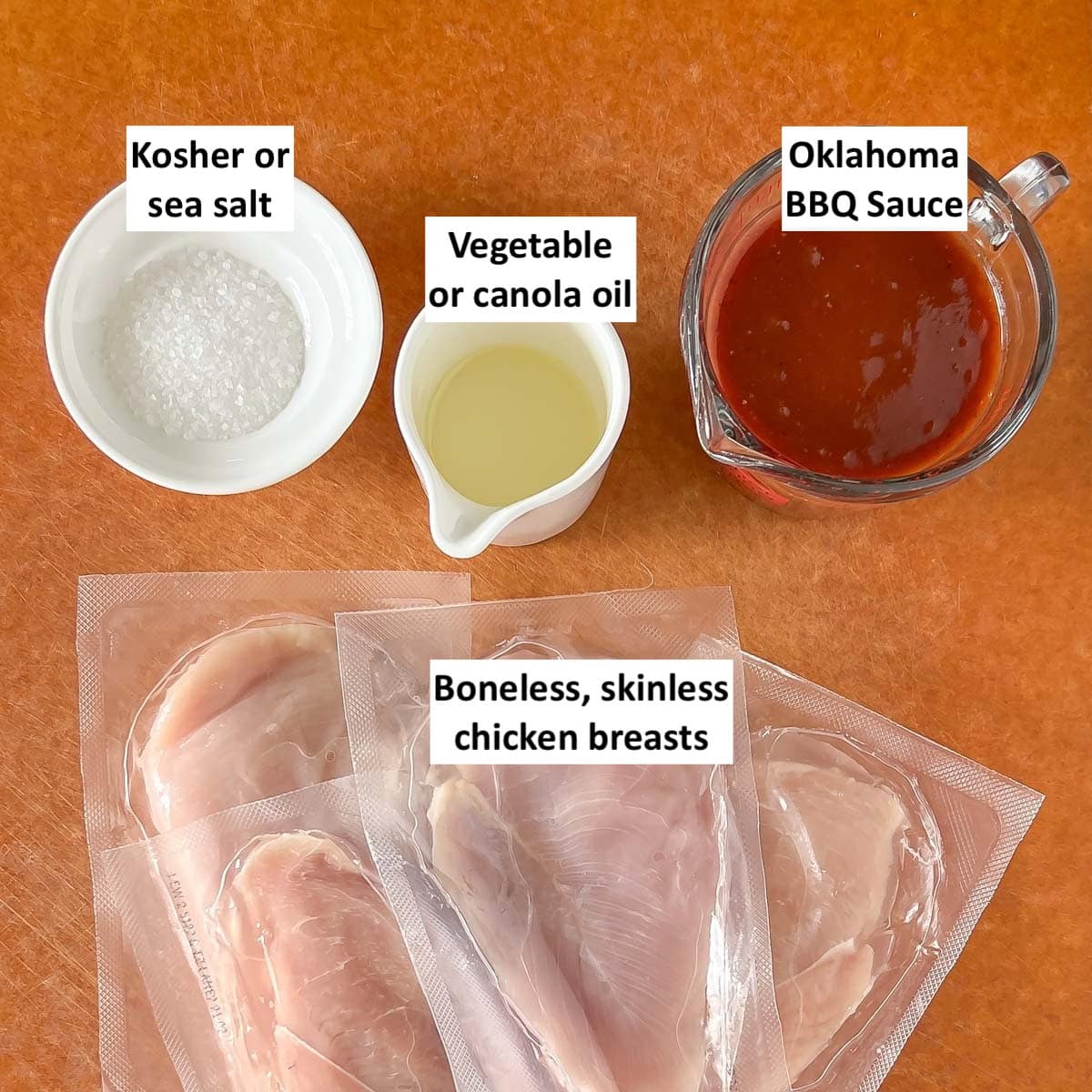 brown board holding 4 ingredients needed for BBQ Chicken Breasts