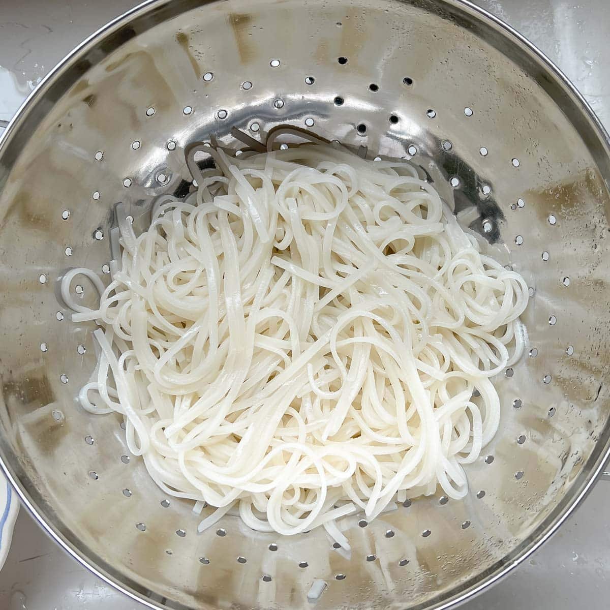 Cooked rice noodles that have been rinsed and drained for this easy beef and broccoli stir-fry recipe.
