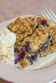 white plate filled with a slice of Berry Cobbler, with a side of ice cream