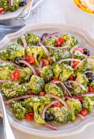 round plate showing Broccoli Salad with a fork on the side