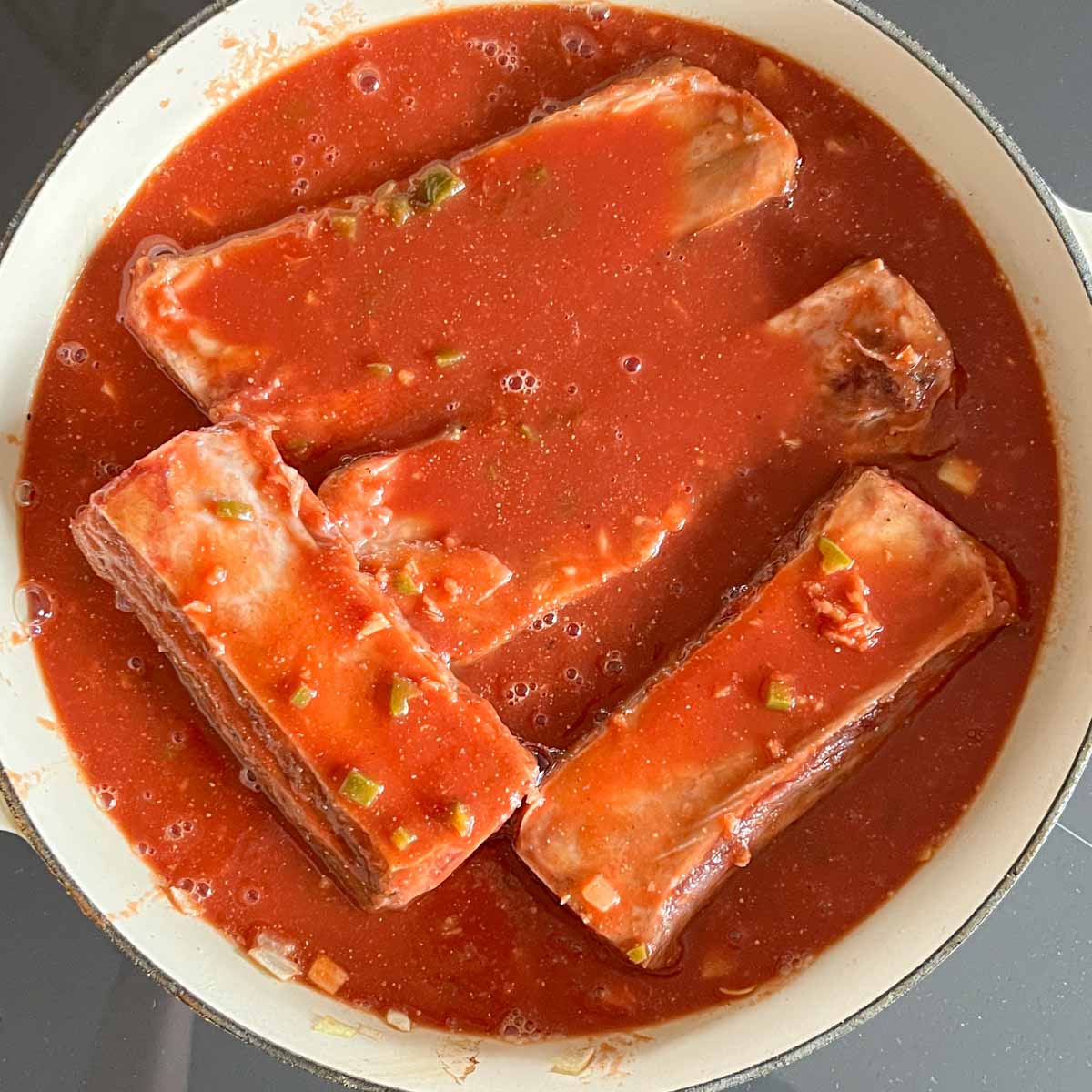 Seared beef short ribs in spicy sauce, before braising