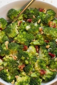 close up of a bowl of broccoli with bacon and walnuts