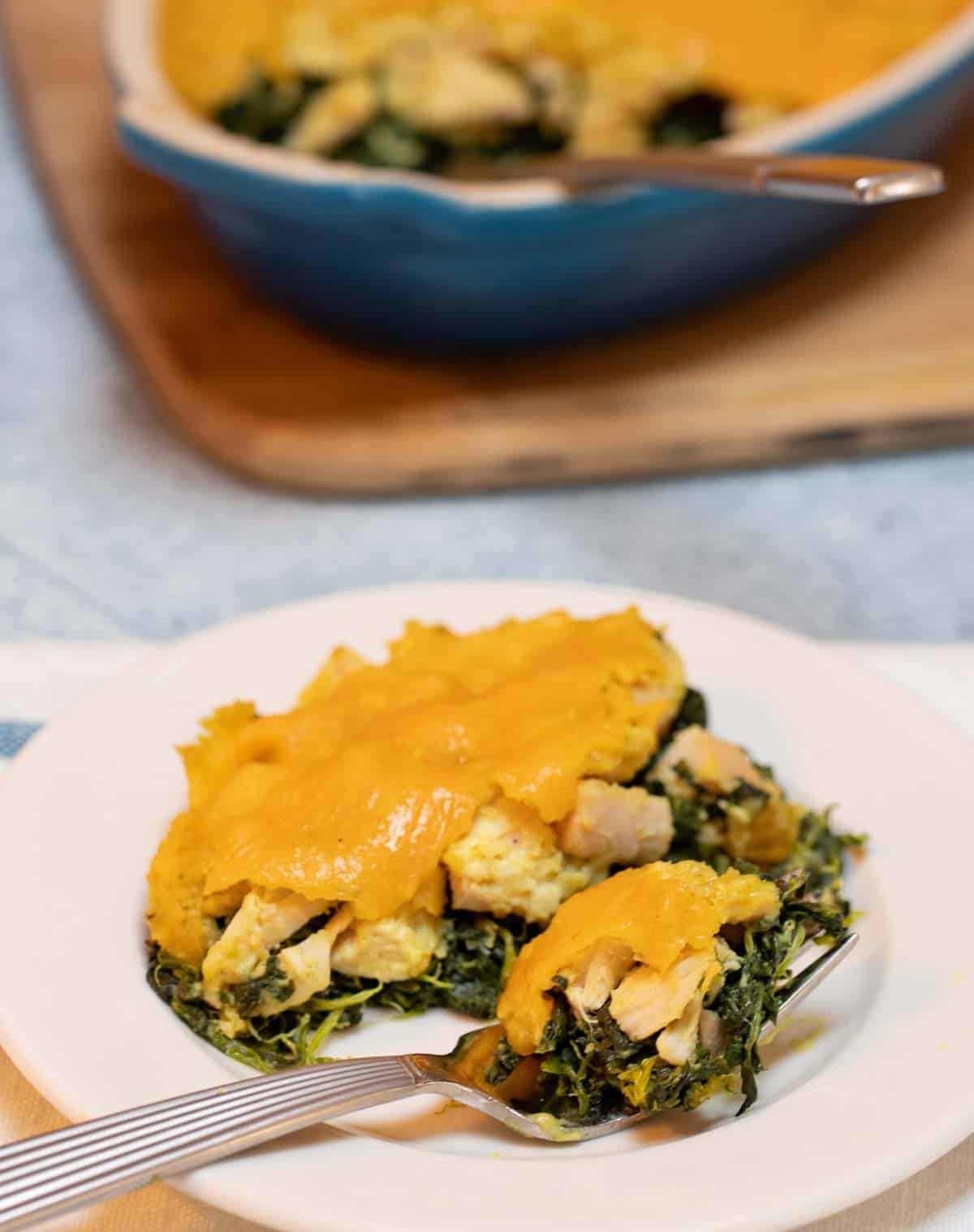 white plate with a portion of Busy Night Chicken with Spinach
