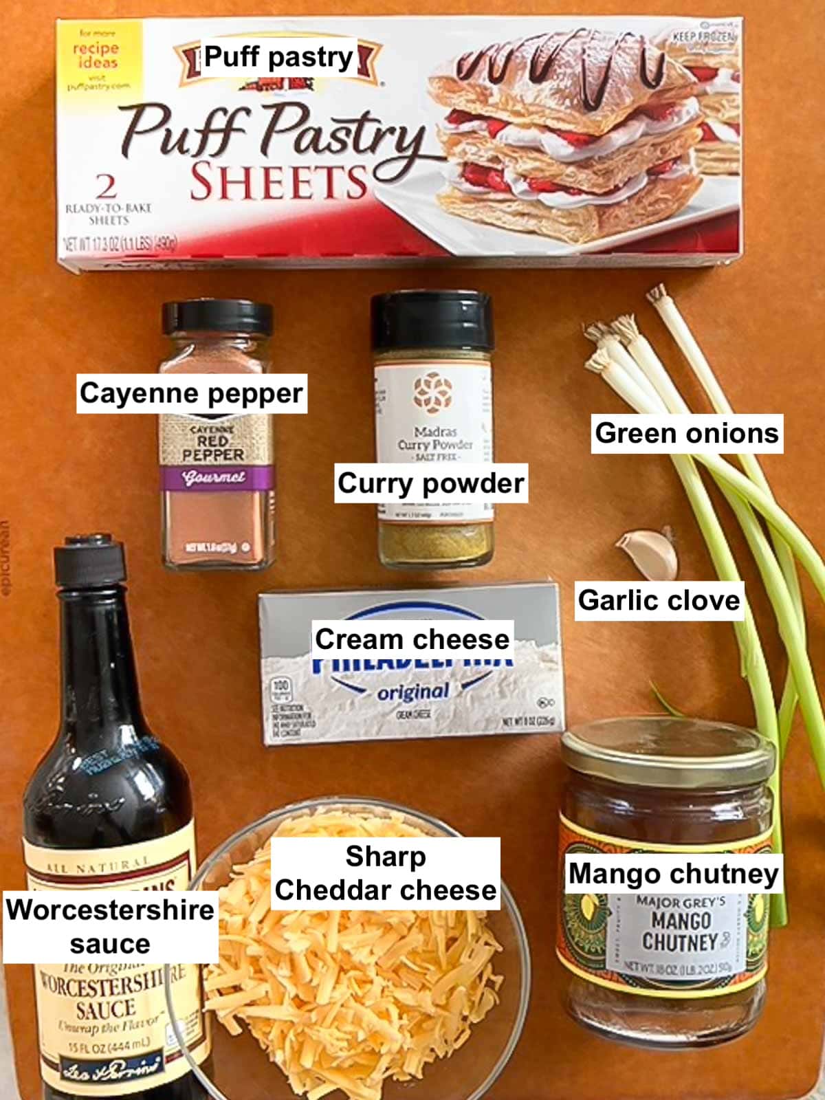 cutting board holding all ingredients for Mini Cheese Tarts, labeled