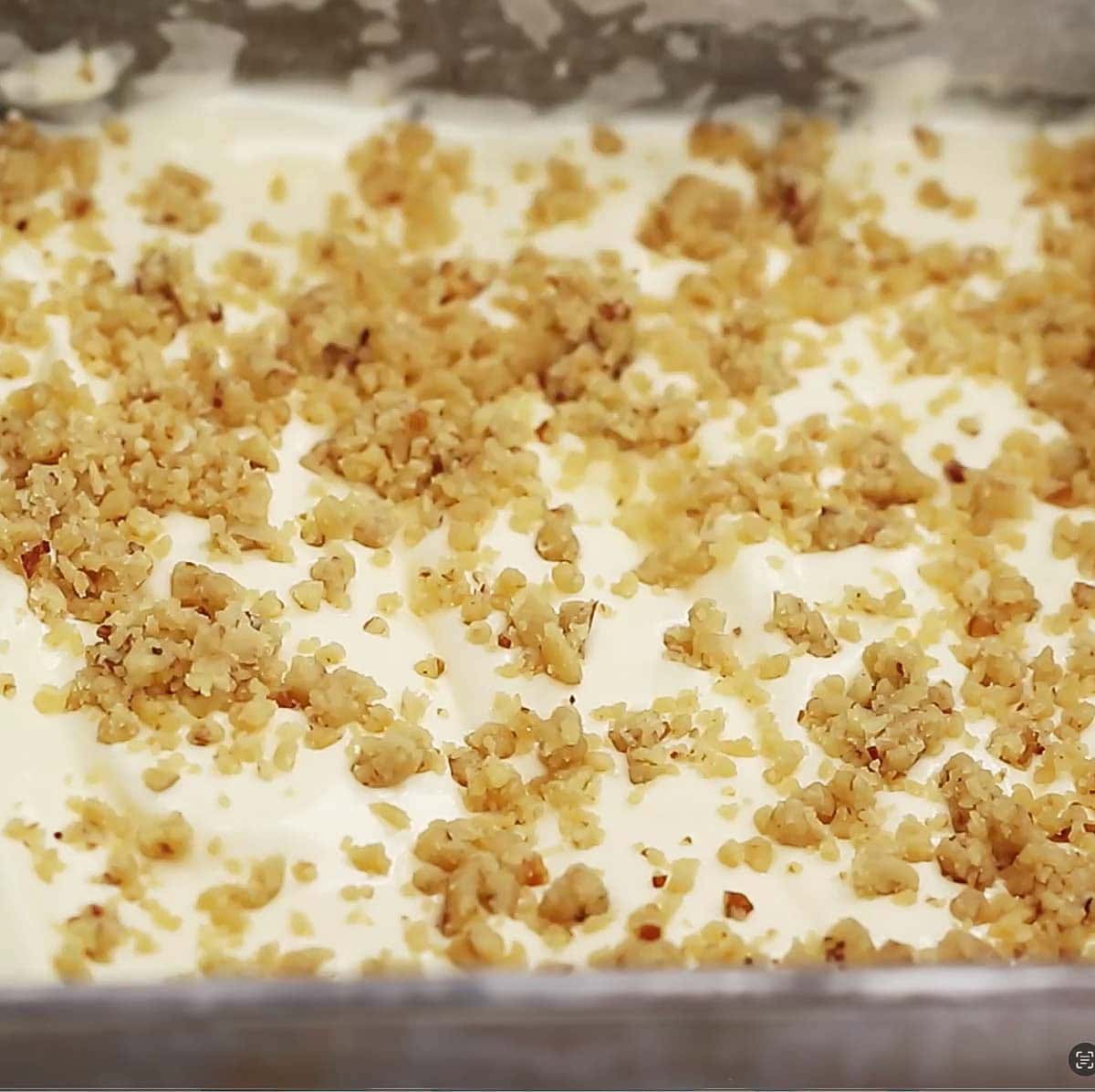 process shot showing the final step before baking of adding the crumb topping