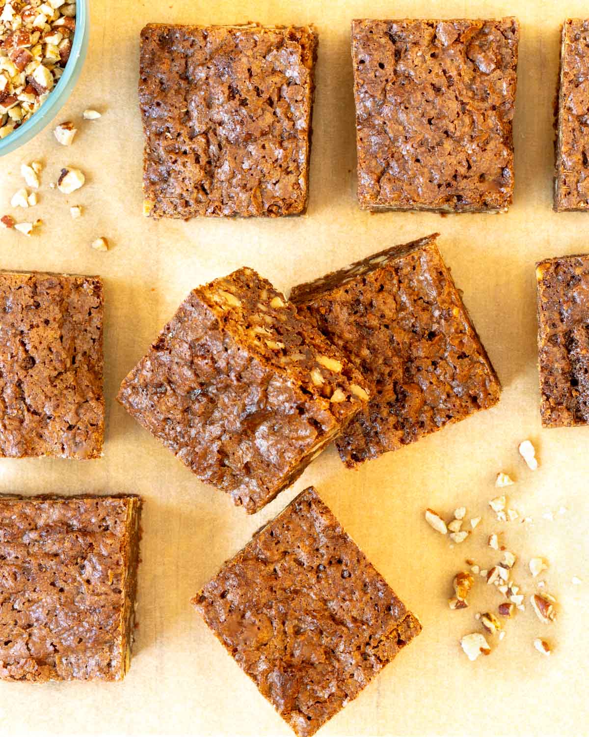 Overhead view of 7 Chewy Chocolate Brownies with chopped nuts on the side