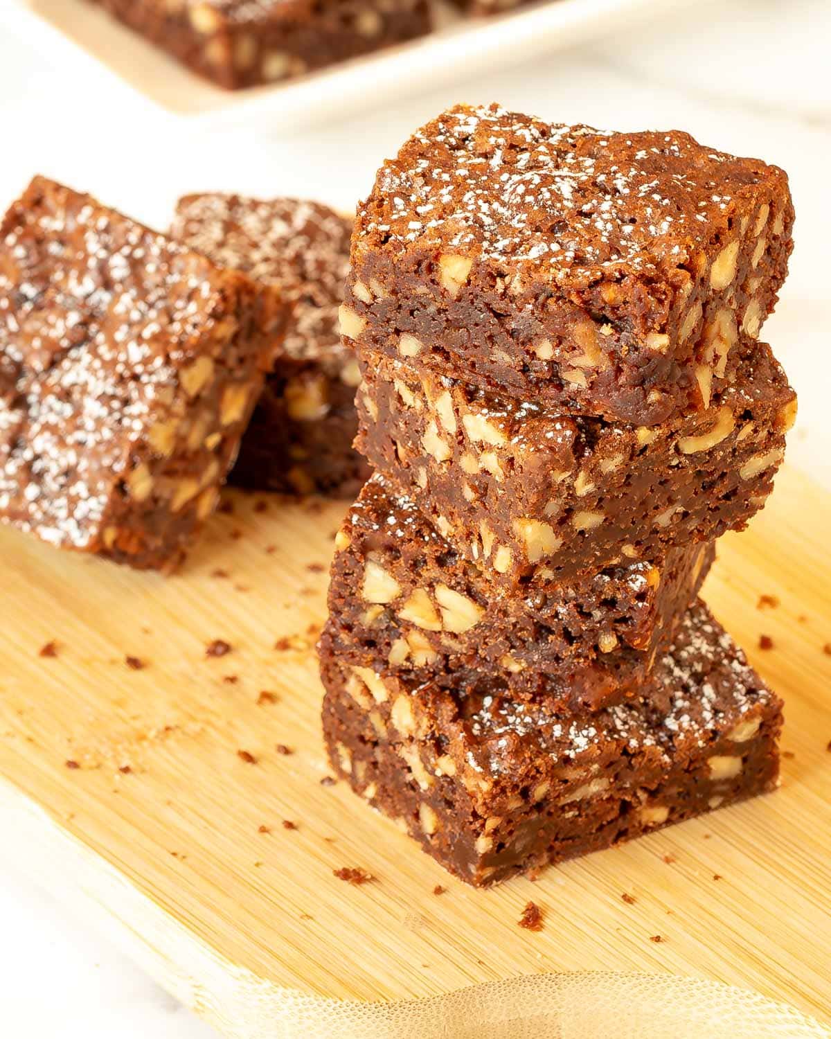 Four Chewy Chocolate Brownies stacked on each other with 2 more on the side