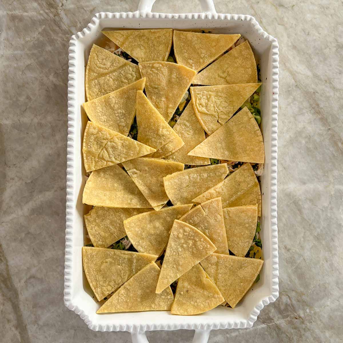 Showing second tortilla layer in casserole