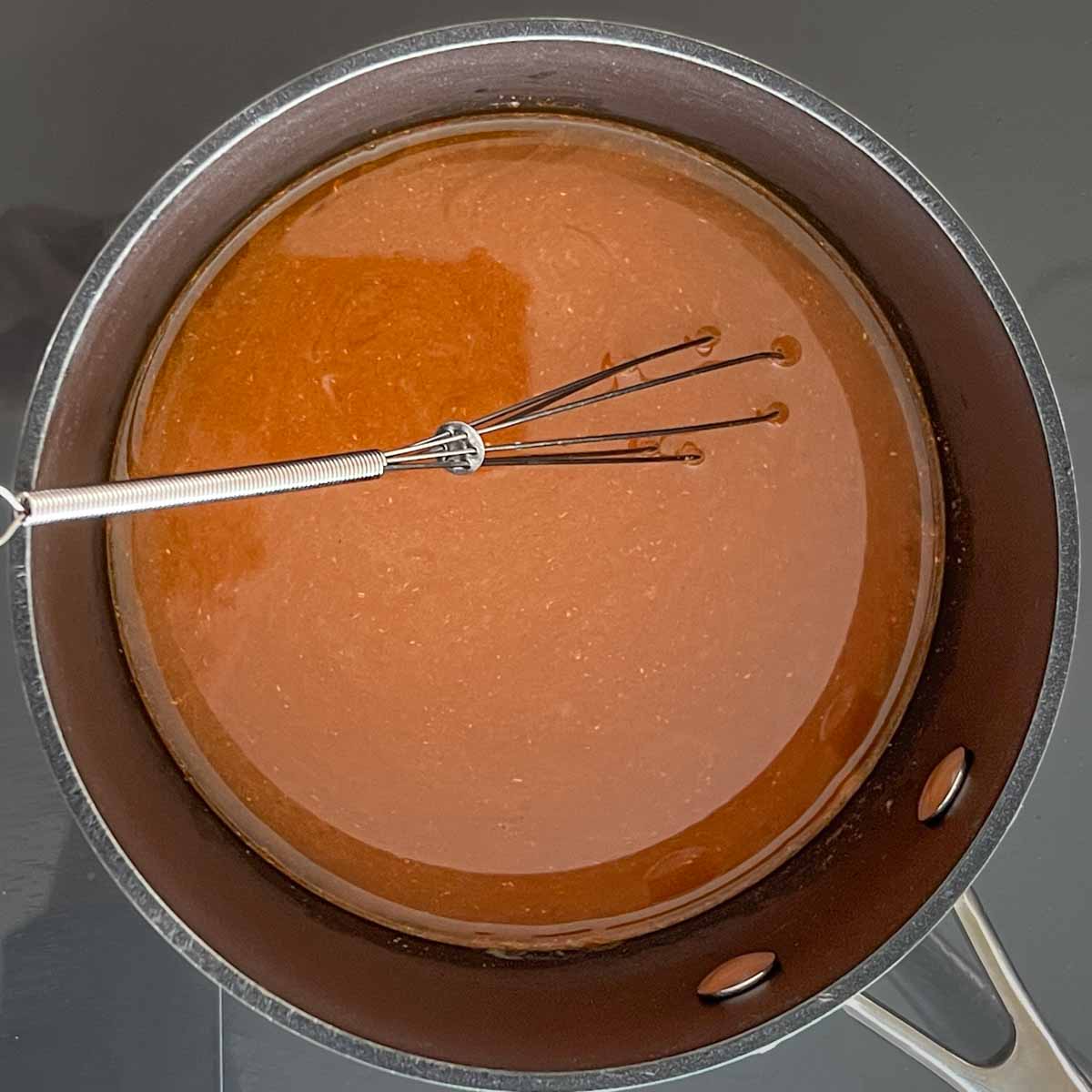 whisking green chile sauce, before adding chiles and yogurt