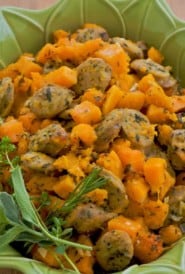 roasted chicken sausage and butternut squash in a green baking dish