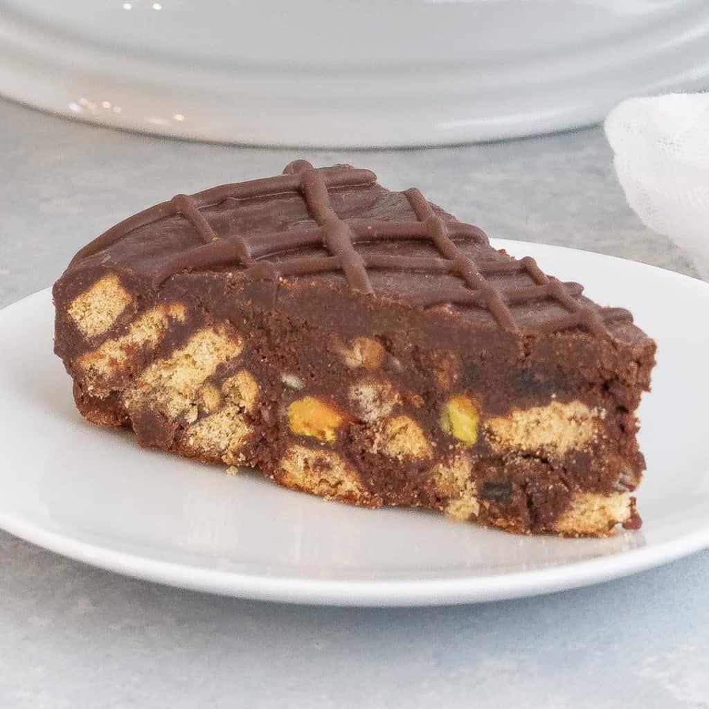 Slice of chocolate biscuit cake on a white plate