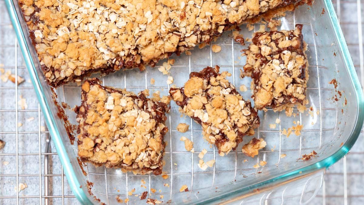Close up of 3 cut cookies in baking dish on top of a wire cooling rack