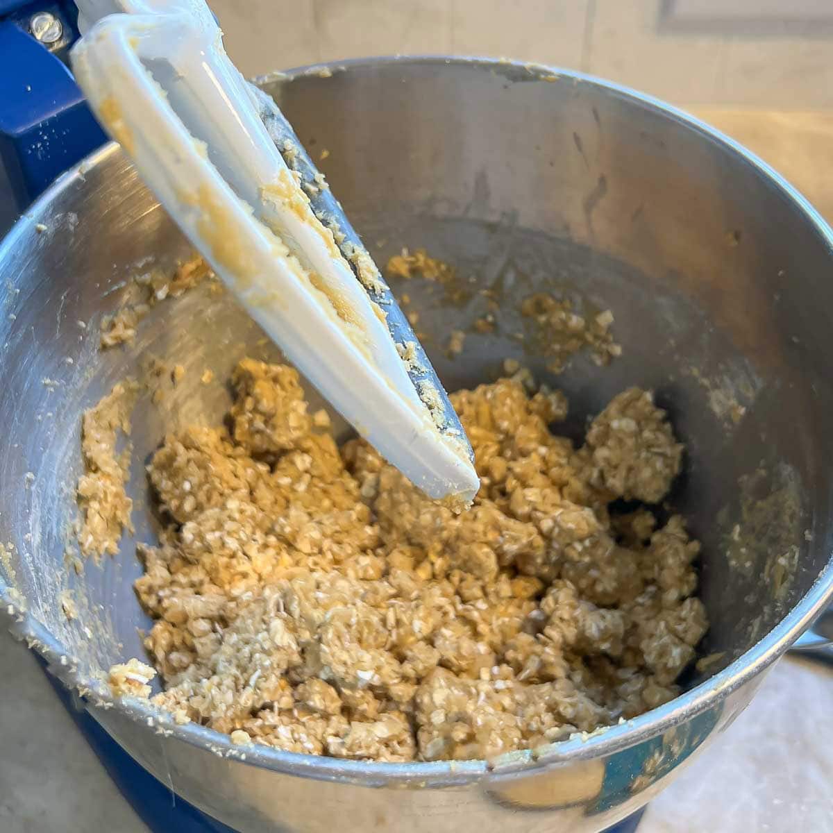 mixing bowl and paddle attachment after blending ingredients for oat cookie layers
