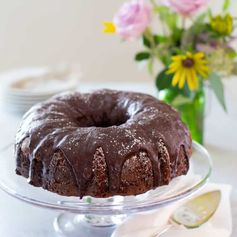 Triple Chocolate Zucchini Cake on glass cake platter
