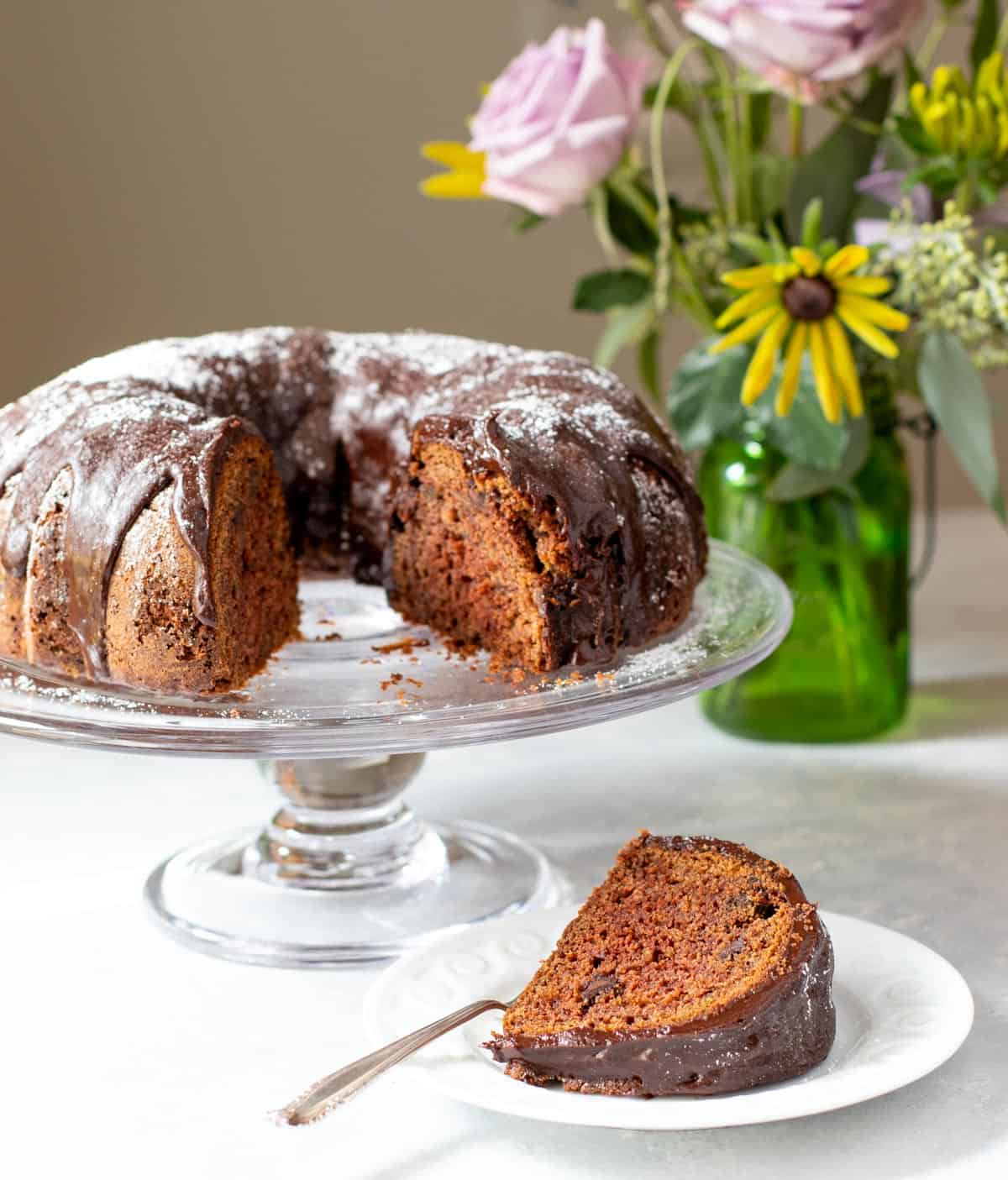 Triple Chocolate Zucchini Cake with slice in front on plate