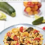 Square blue plate filled with Grilled Corn, Zucchini and Tomato Salad