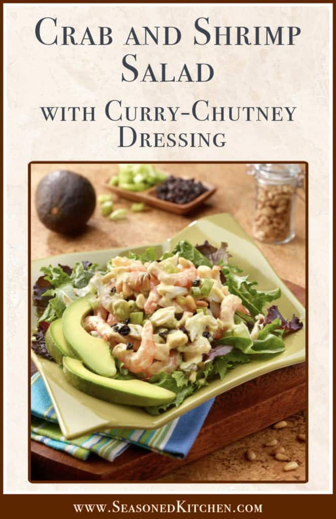 serving platter with Crab and Shrimp Salad atop mixed greens and sliced avocado on the side.