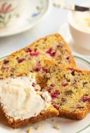 Two slices of Cranberry Nut Bread with butter