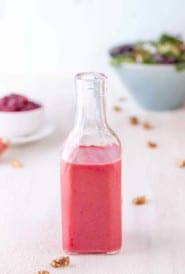 Narrow necked bottle filled with Cranberry Vinaigrette.