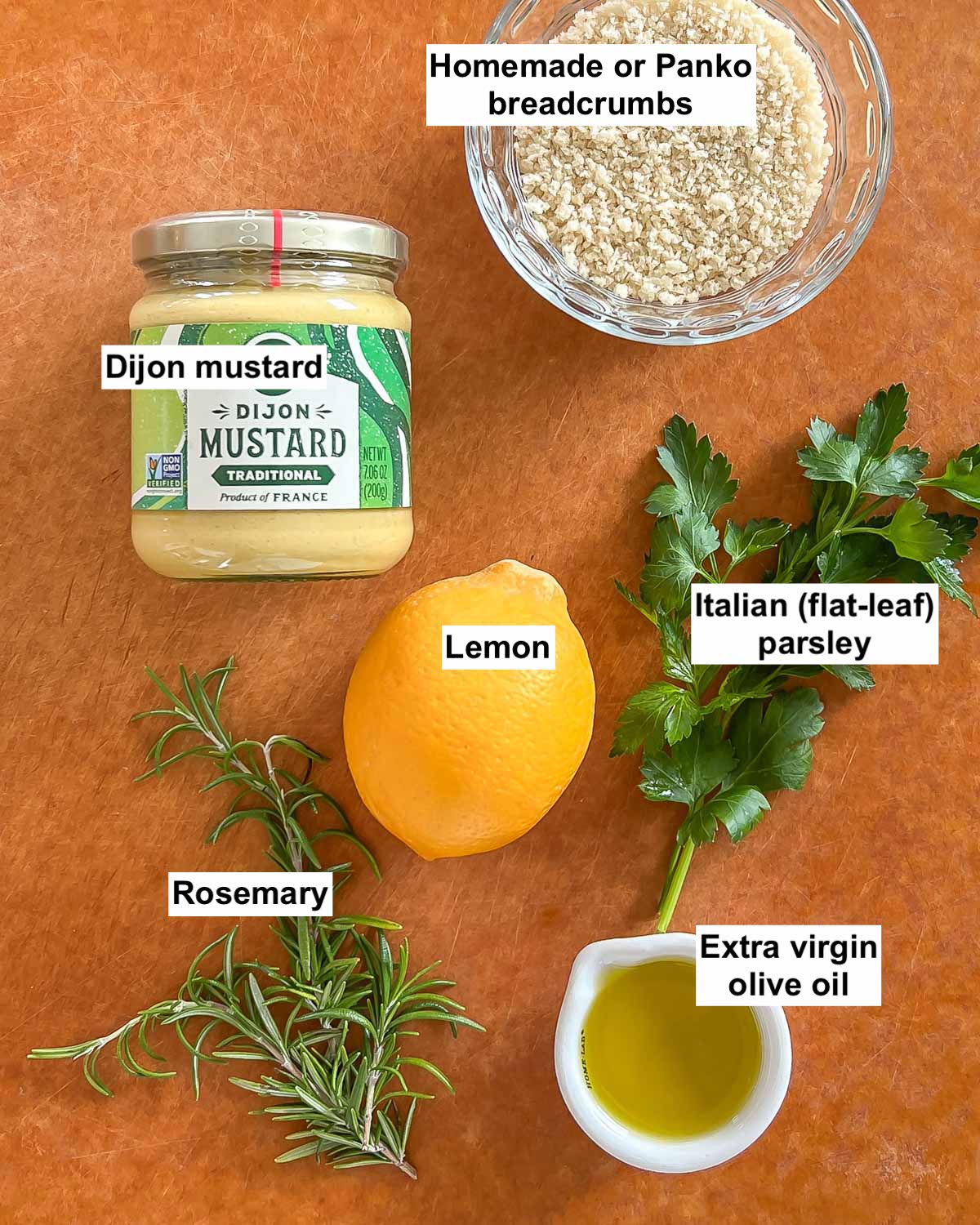 Six ingredients in Dijon-Herb Crumb Crust topping for Rack of lamb arranged on a cutting board. Labeled