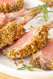 White platter holding individual chops from Crusted Rack of Lamb, showing crust detail