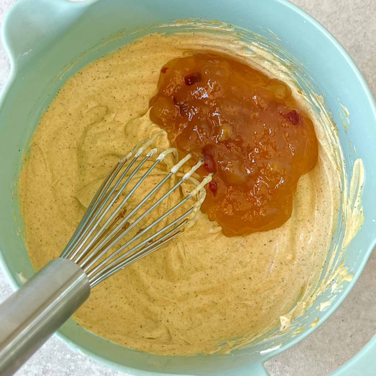 whisking mango chutney into curry dressing