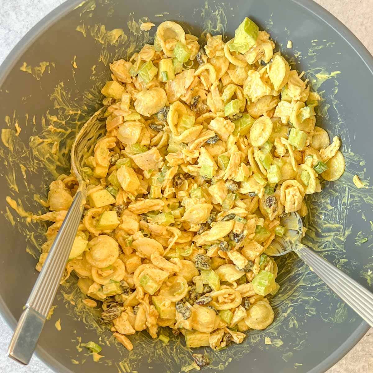 tossed Curry Chicken Salad with Pasta in a large bowl