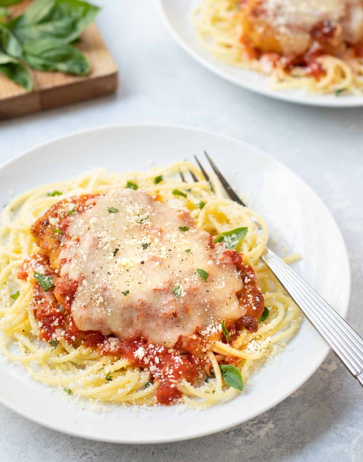 breaded chicken breast topped with marinara sauce and melted mozzarella cheese over pasta