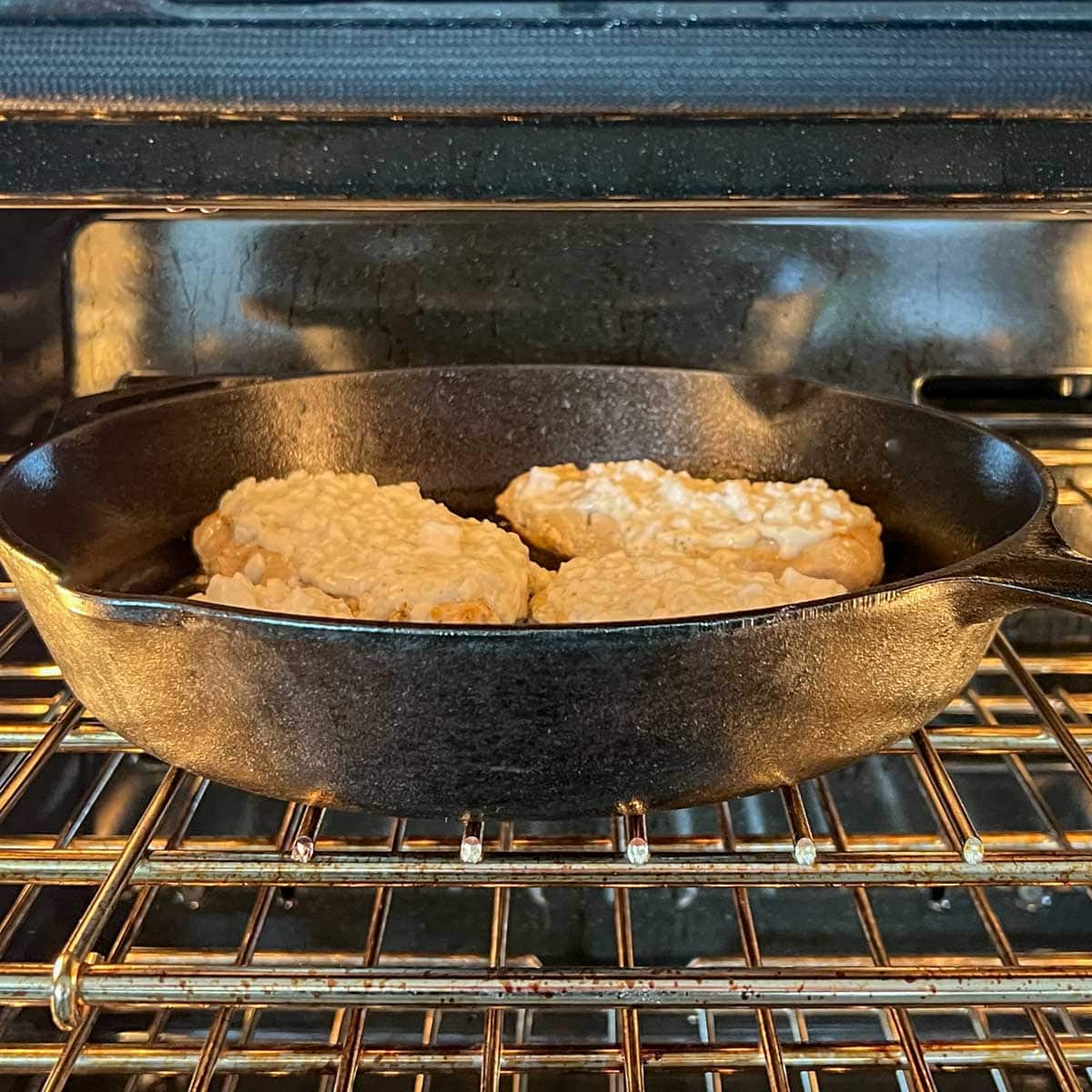 Chicken breasts with feta-yogurt topping under the broiler cooking