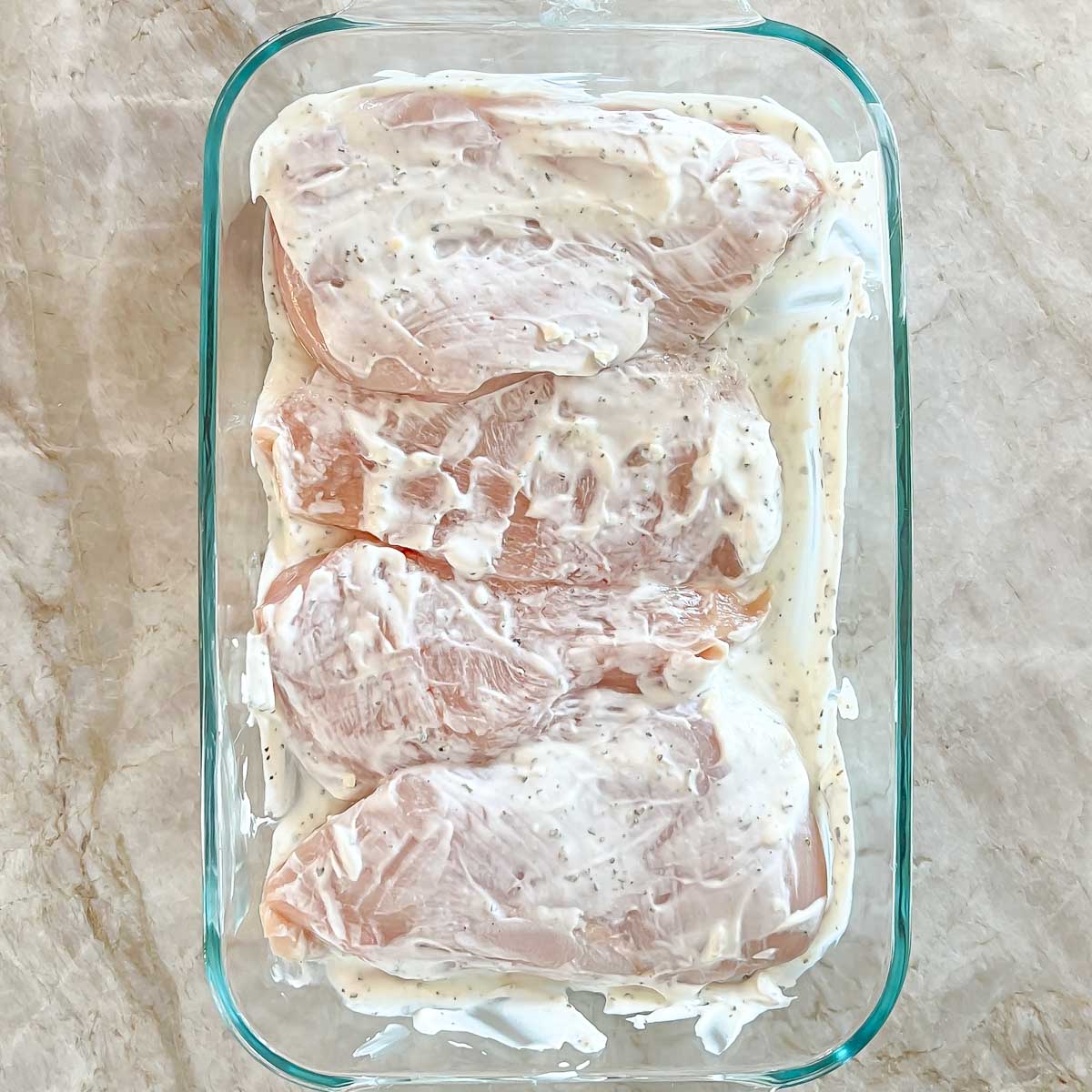 Chicken breasts marinating in yogurt marinade