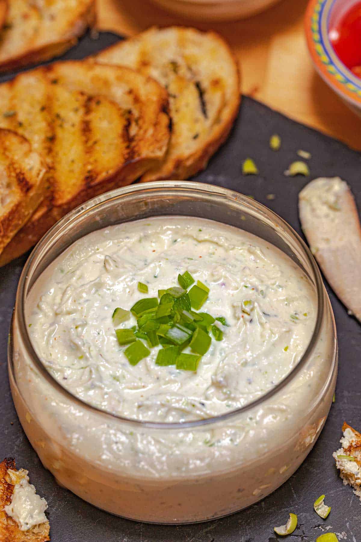 glass bowl on black tray, filled with Feta Mousse