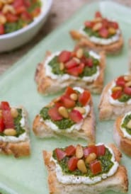 platter holding two bite Tomato, Pesto and Goat Cheese Crostini