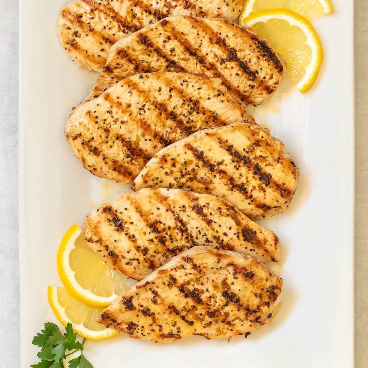 overhead shot of Lemon Pepper Grilled Chicken on a white platter