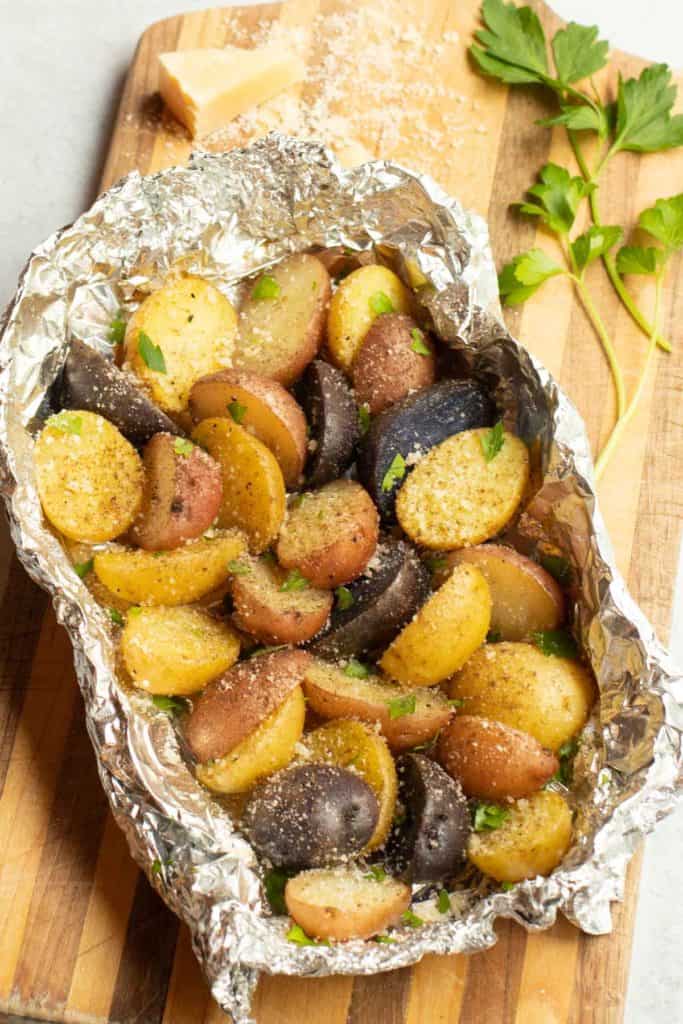 Foil packet filled with griled new potatoes, seasoned with Parmesan Cheese, parsley and truffle zest.