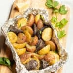 Foil packet filled with grilled new potatoes, seasoned with Parmesan Cheese, parsley and truffle zest.