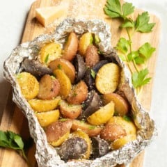 Foil packet filled with grilled new potatoes, seasoned with Parmesan Cheese, parsley and truffle zest.