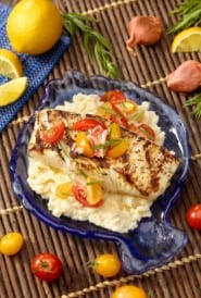 Fish shaped blue platter with Halibut with Celery Root Purée and Tomato Garnish.