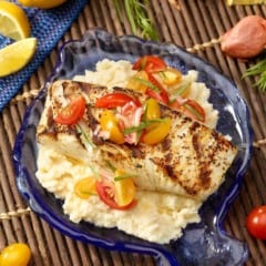 Fish shaped blue platter with Halibut with Celery Root Purée and Tomato Garnish.