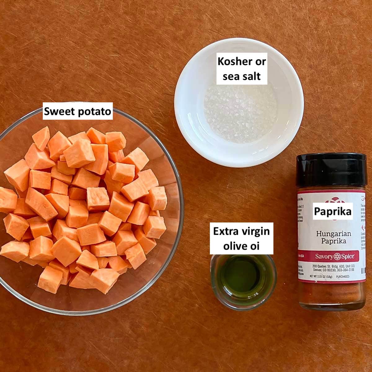 Cutting board holding ingredients in Potato Croutons for Healthy Broccoli Soup, each one labeled