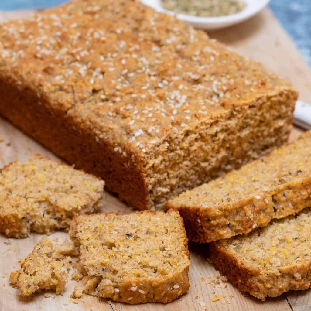 Loaf and slices of Herb Quick Bread on a cutting board