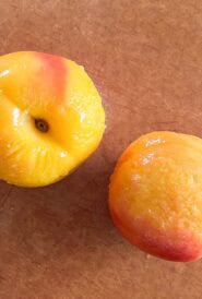 Freshly peeled peaches, ready to be sliced and pitted for use in your favorite recipes.